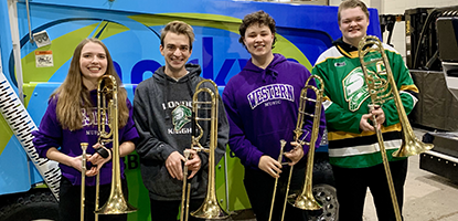 Trombone students standing in front of a zamboni at Canada Life Place